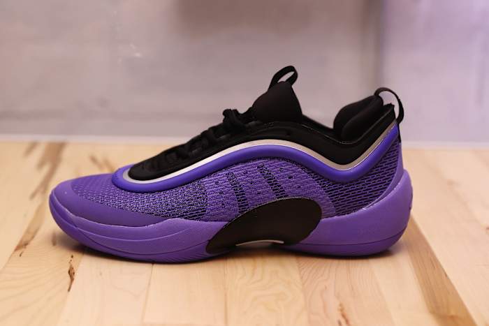 Side view of Donovan Mitchell's purple and black adidas sneaker.